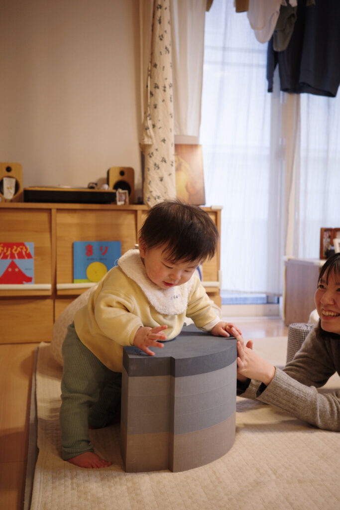 ボブルスのゾウを使って掴まり立ちをする0歳児